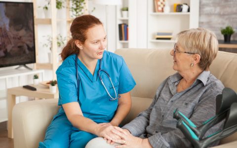 female-nurse-having-conversation-with-pensioner-woman-nursing-home-1